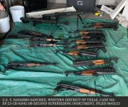 Photo of 20 AK-47 type firearms and two .50 caliber rifles seized on August 21, 2023, in the Western District of Texas. Seventeen rifles displayed
