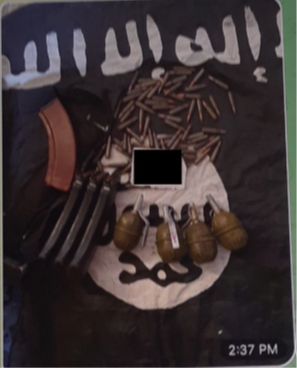 ISIS Photograph An image of ammunition, and grenades on top of an ISIS flag.