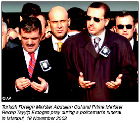 Turkish Foreign Minister Abdullah Gul and Prime Minister Recep Tayyip Erdogan pray during a policemans funeral in Istanbul, 16 November 2003.