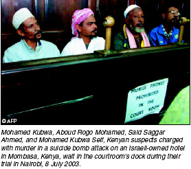 Kenyan suspects charged with murder wait in the courtrooms dock during their trial in Nairobi.