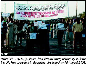 More than 100 Iraqis march to a wreath-laying ceremony outrside the UN Headquarters in Baghdad, destroyed on 19 August 2003. [AFP photo]