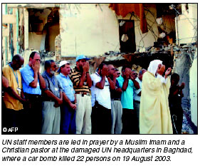 UN staff members are led in prayer by Muslim Imim and a Christian pastor at the damaged UN headquarters in Baghdad, where a car bomb killed 22 persons on 19 August 2003. [AFP photo] 