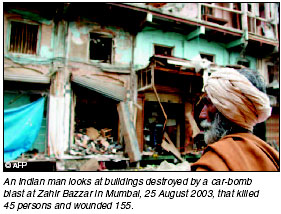 An Indian man looks at building destroyed by a car-bomb blast at Zahir in Bombay, 27 August 2003, that killed 45 persons and wounded 155. AFP photo