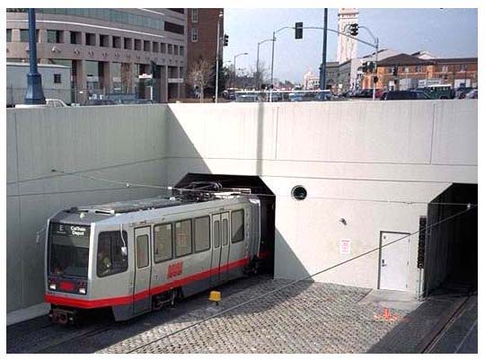 Fencing and grade change help segregate tunnel entrances and exits from nearby public areas